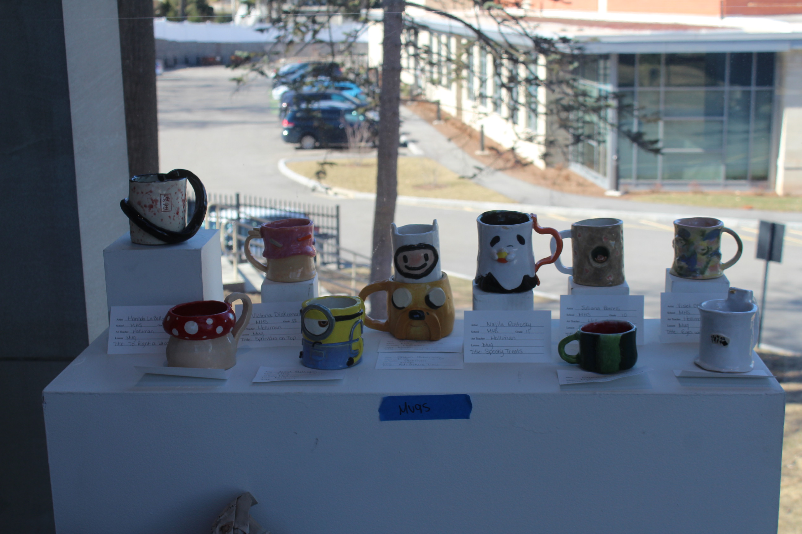 Student pottery on display in the gallery
